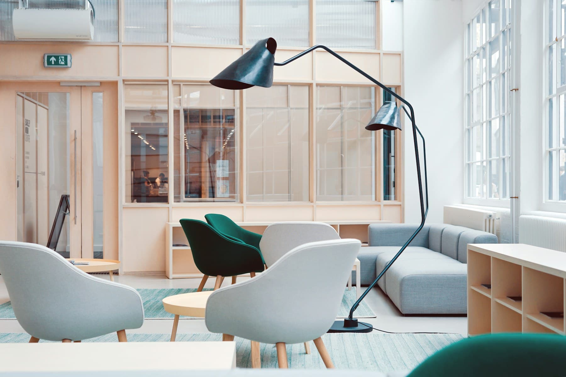 Minimal modern lounge with soft seating, wood, and daylight